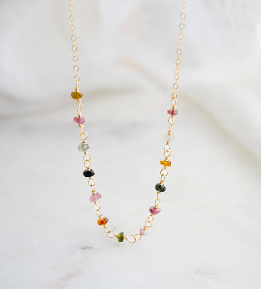 Tiny Natural Tourmaline gemstones arranged into a 14k gold filled chain. Stone colors include: pink, black, green, and brown.