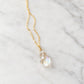 A faceted mystic topaz gemstone set on a dainty 14k gold filled chain. The stone is clear, but shimmers rainbow colors when turned from side to size. This pendant is handmade in Connecticut by Gemnia.