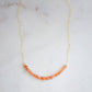 A beaded bar of sunstone crystals set on a gold filled chain.
