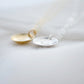 Om symbol stamped into a circle disc and put on a gold filled chain. Side view of gold and sterling silver options