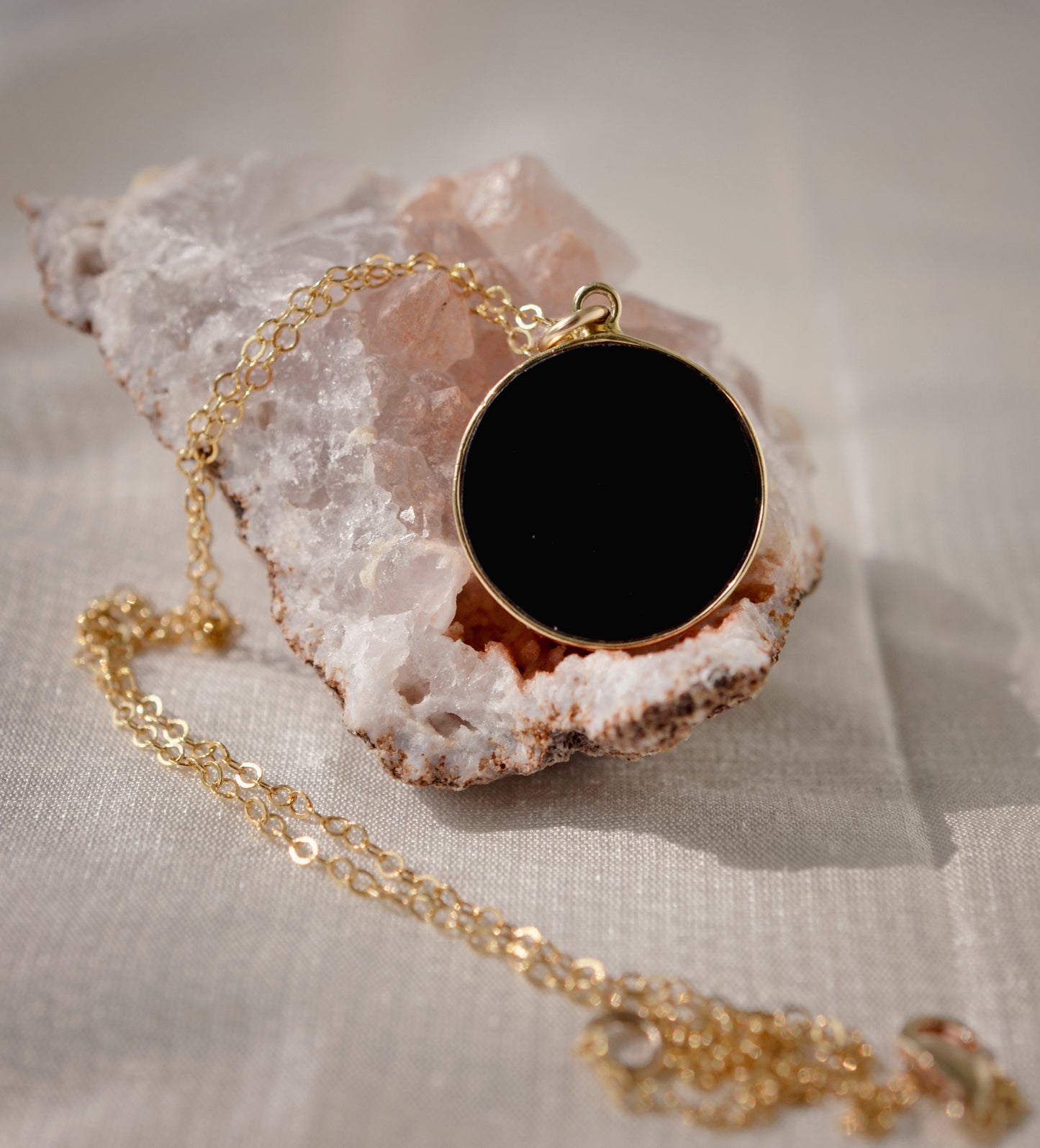 Smooth Polished Black Onyx Circle Pendant on Simple Gold Chain. 