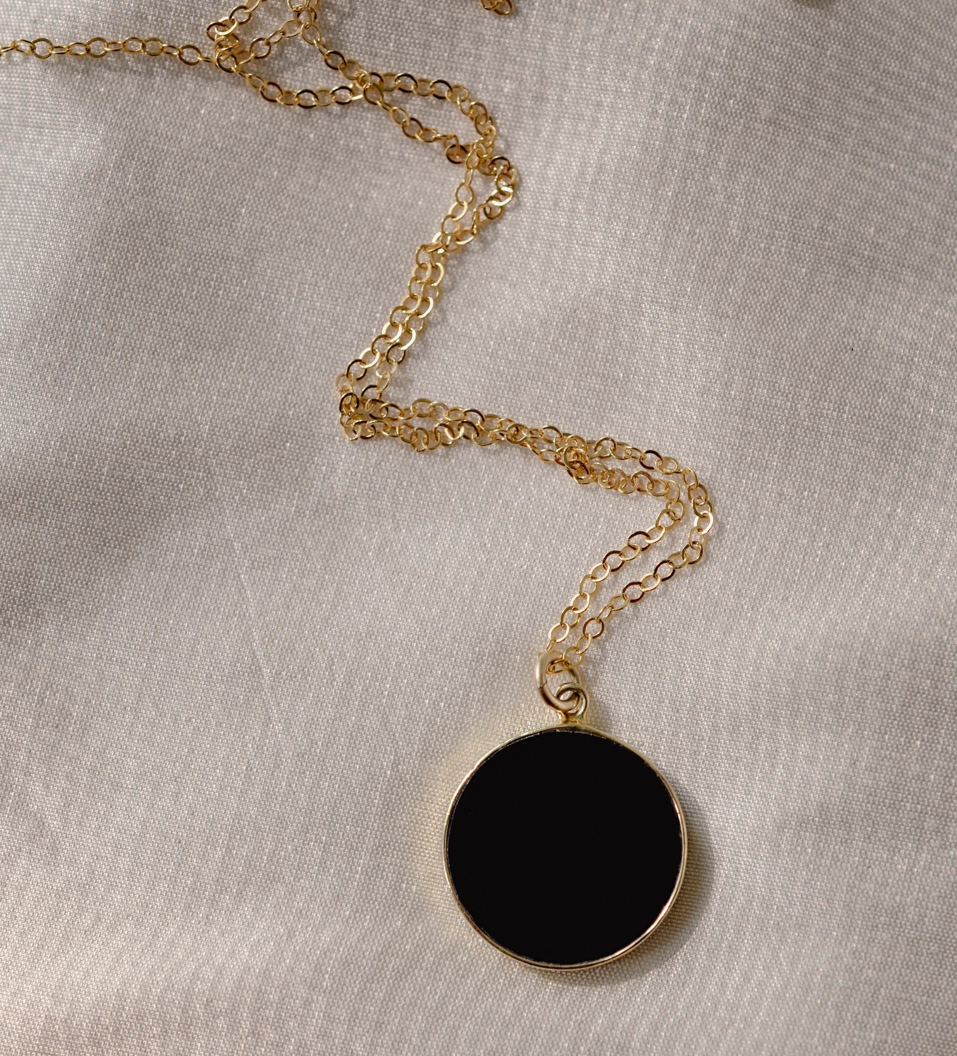 Smooth Polished Black Onyx Circle Pendant on Simple Gold Chain. 
