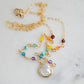 Rainbow, pride, or chakra necklace with tiny gemstones and a white freshwater pearl. The 14k gold filled style is shown.