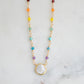 Rainbow, pride, or chakra necklace with tiny gemstones and a white freshwater pearl. The 14k gold filled style is shown.