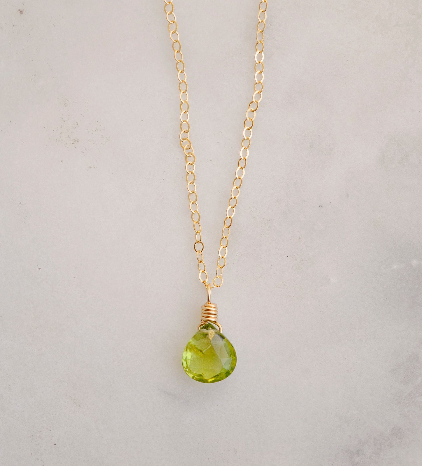 Natural green Peridot faceted teardrop suspended from a 14k gold filled cable chain.
