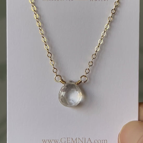 A clear, natural crystal quartz faceted teardrop set onto a 14k gold filled chain. Movie.