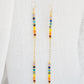 Two long, straight bars of crystals arranged in a rainbow pattern separated by a dainty chain. The gold style is shown. 