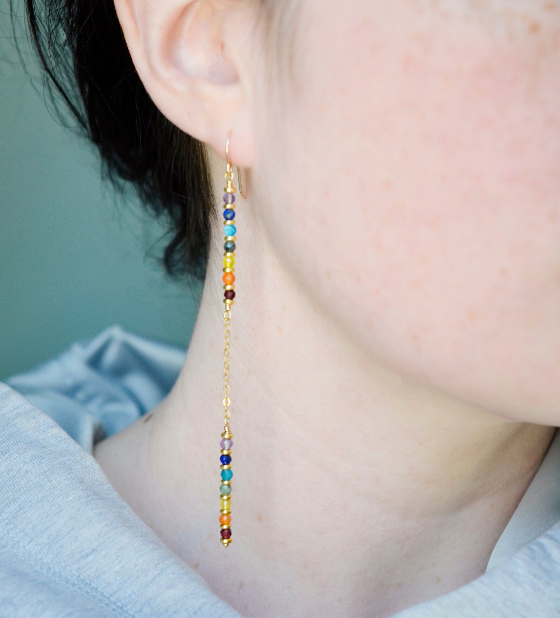 Modeled image. Two long, straight bars of crystals arranged in a rainbow pattern separated by a dainty chain. The gold style is shown. 
