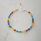 Tiny gemstone beaded bracelet in rainbow colors. Colors include: blue, green, yellow, red, orange, and purple.