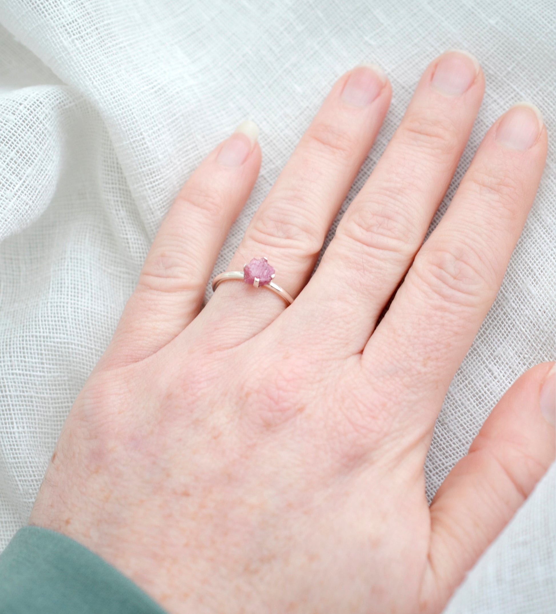 Modeled image of the Raw Pink Tourmaline crystal set on a sterling silver ring. Please note, the stone is a brighter pink than shown in this image.