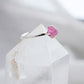 Side view of a raw Pink Tourmaline crystal set onto a sterling silver ring.
