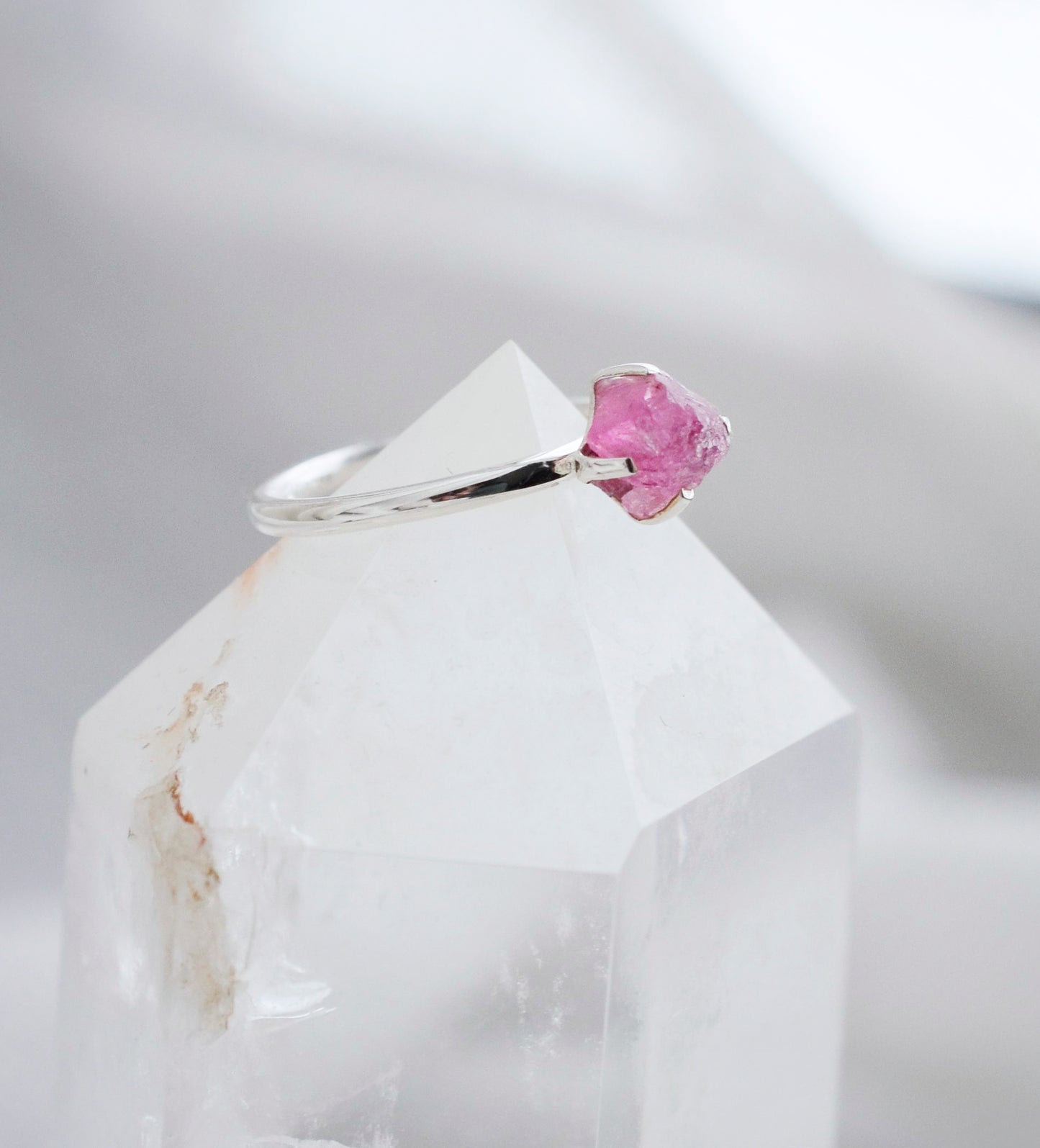 Side view of a raw Pink Tourmaline crystal set onto a sterling silver ring.