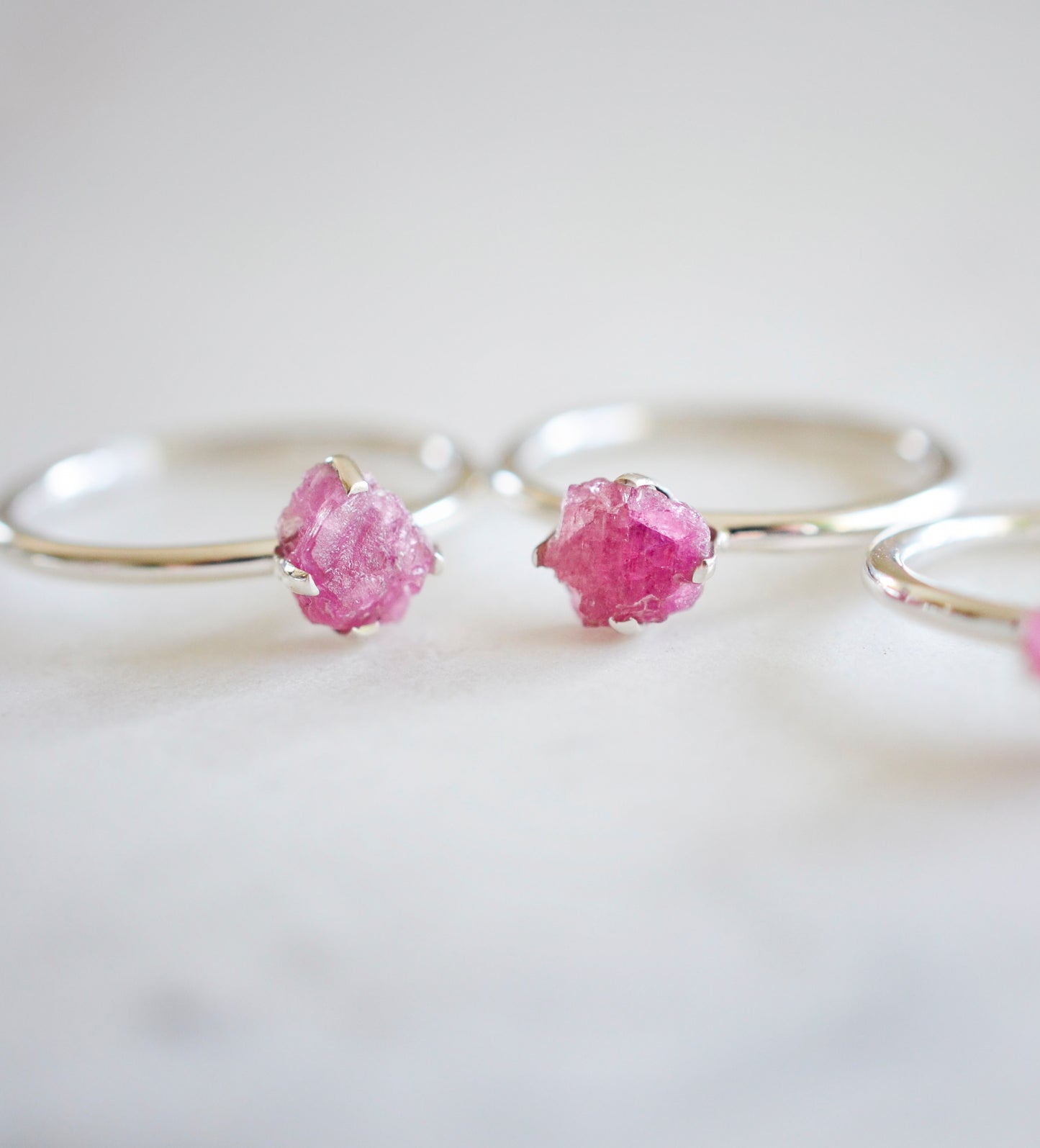 Raw Pink Tourmaline crystals set onto sterling silver rings. Showing two rings. 