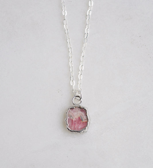 Natural pink Rhodochrosite sliced gemstone bezeled in sterling silver and set on a sterling chain.
