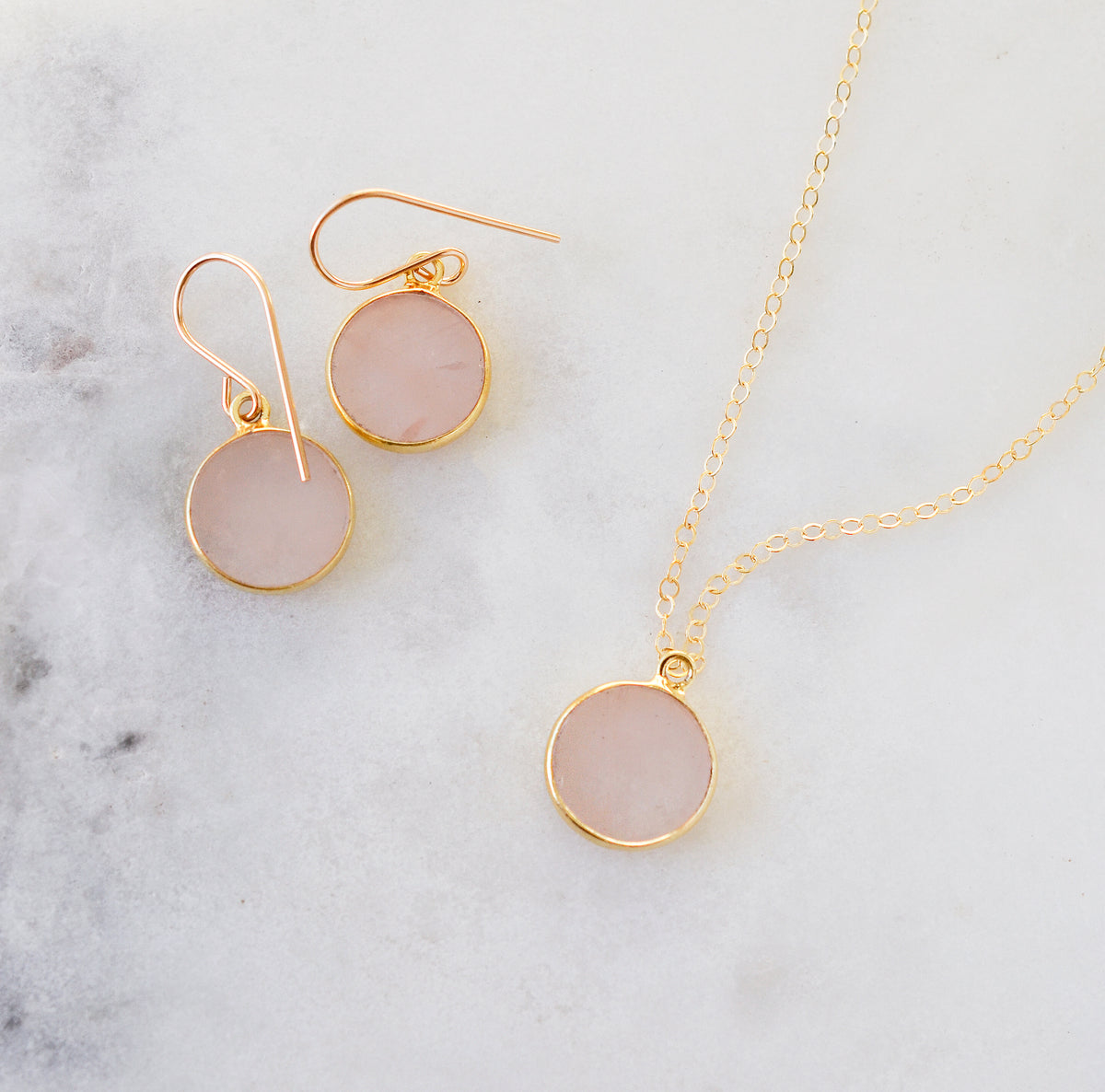 Pale natural rose quartz necklace and earring set in 14k gold filled. The stones are smooth polished coin shapes. and slightly translucent. Also available in sterling silver. 
