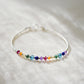 this dainty minimalist bracelet is handmade in Connecticut with natural crystal gemstones in order of the chakras. The stones are arranged like a rainbow. 