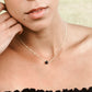 Natural round black Lava, or Basalt, stone placed onto a sterling silver chain. Modeled image. 