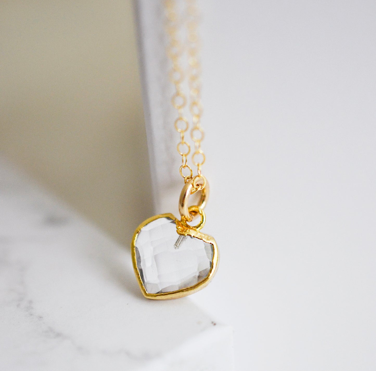 clear quartz gemstone in a heart shape on a 14k gold filled chain.