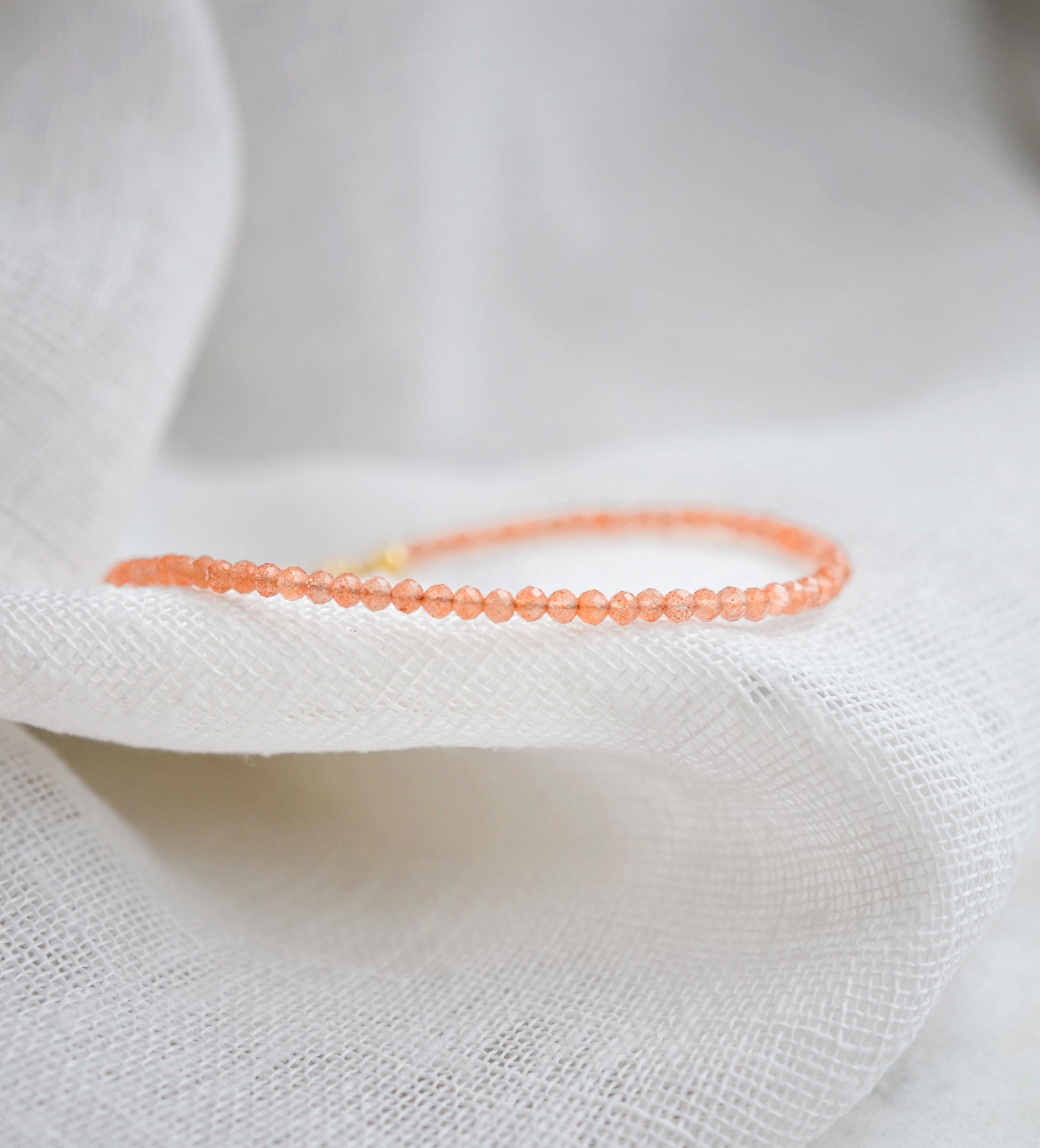 Genuine orange Sunstone beaded bracelet. The stones are round and faceted.