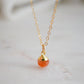 Natural orange Sunstone necklace. The stone is a faceted round and set onto a 14k gold filled chain.