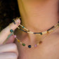 Multi color Tourmaline drops chain necklace. Shown in gold. Stone colors include: pink, green, black, yellow, or brown. Close up modeled image. Shown with a beaded tourmaline and black onyx necklace.