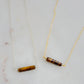Tiger Eye gemstone necklace. A smooth polished Tiger Eye stone in a bar or tube shape shown in the sterling silver an 14k gold filled chain styles.