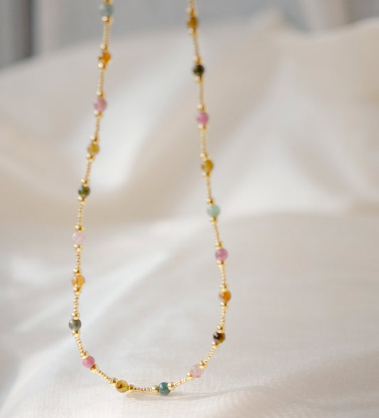 Multicolored, smooth polished Tourmaline gems hand-beaded with gold plated glass beads. Colors range from pink, green, brown, yellow, or black.