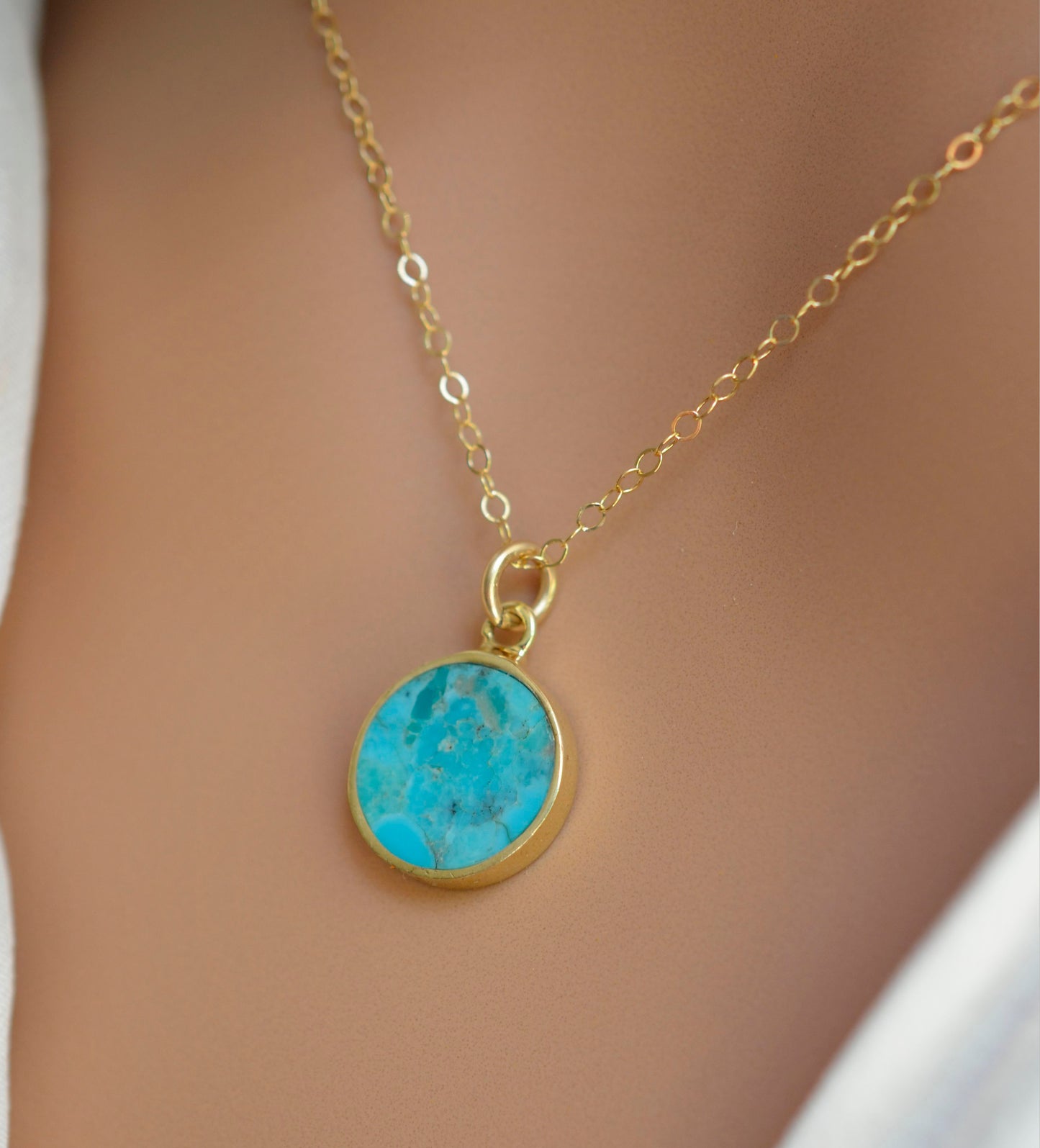 Round aqua blue Turquoise set into a gold bezel and suspended from a 14k gold filled chain.