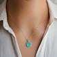 Round aqua blue Turquoise set into a gold bezel and suspended from a 14k gold filled chain.