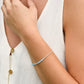 A woman modeling a handmade beaded aquamarine bracelet in sterling silver. Also available in 14k gold filled. 