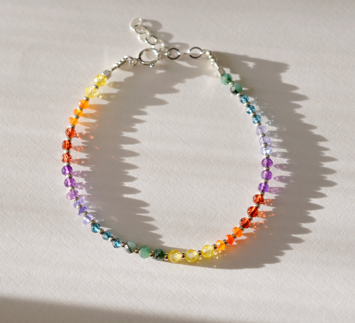 Handmade real gemstone bracelet for the Chakras or Pride. Stones include: Garnet, amethyst, topaz, emerald, carnelian, CZ, and tanzanite.