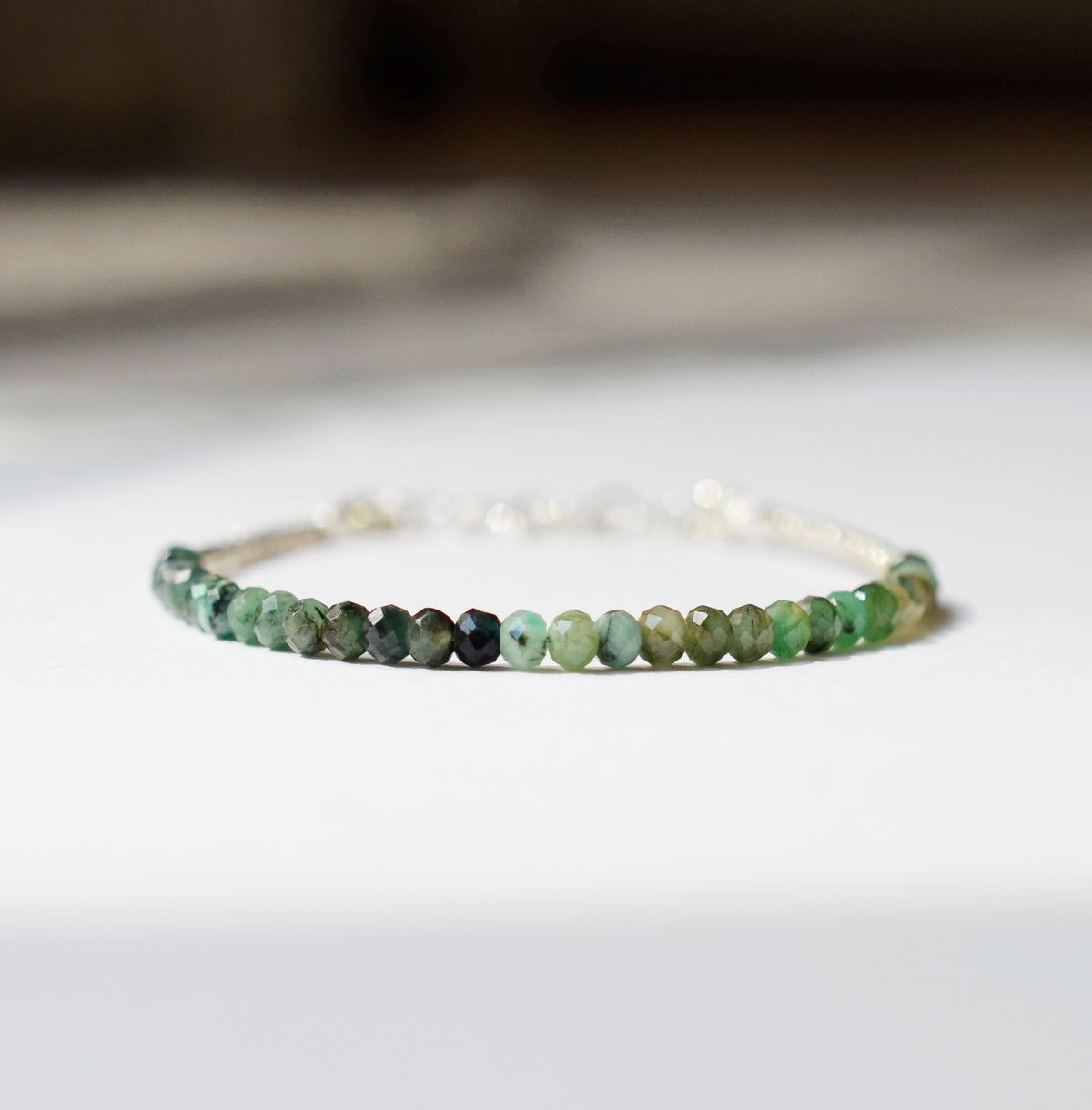 A raw emerald bracelet in shades of light to dark green. Each bracelet is handmade in Connecticut, USA and is perfect for everyday stacking. Also available in 14k gold filled. 