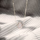 Dainty pink Rose Quartz oval coin shaped pendant with silver bezel. Chain is sterling silver.