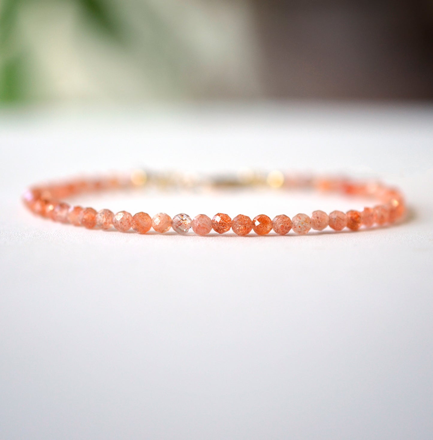 Dainty Sunstone beaded bracelet with orange to clear glittering gemstones. Clasp is sterling silver or gold filled. 