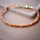 Dainty Sunstone beaded bracelet with orange to clear glittering gemstones. Clasp is sterling silver or gold filled. 